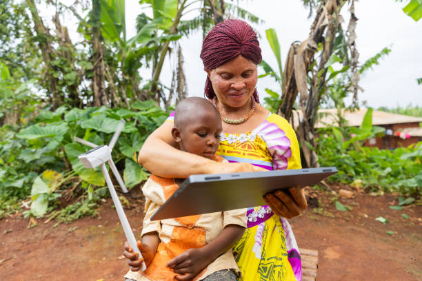 A woman demonstrating green energy to a little boy